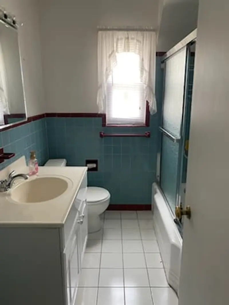 Dated bathroom with teal and maroon tile, Valley Stream, NY