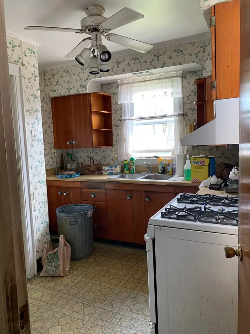 Dated kitchen with wood cabinets and floral wallpaper, Valley Stream, NY