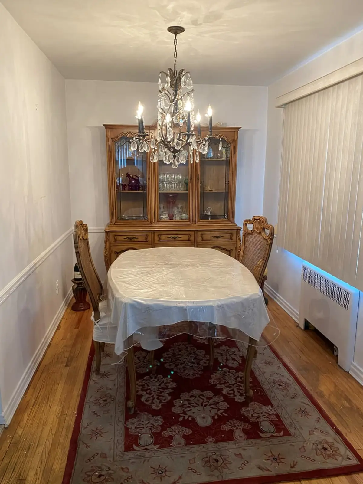 Wondering what your Valley Stream house is worth: formal dining room with a chandelier and china cabinet