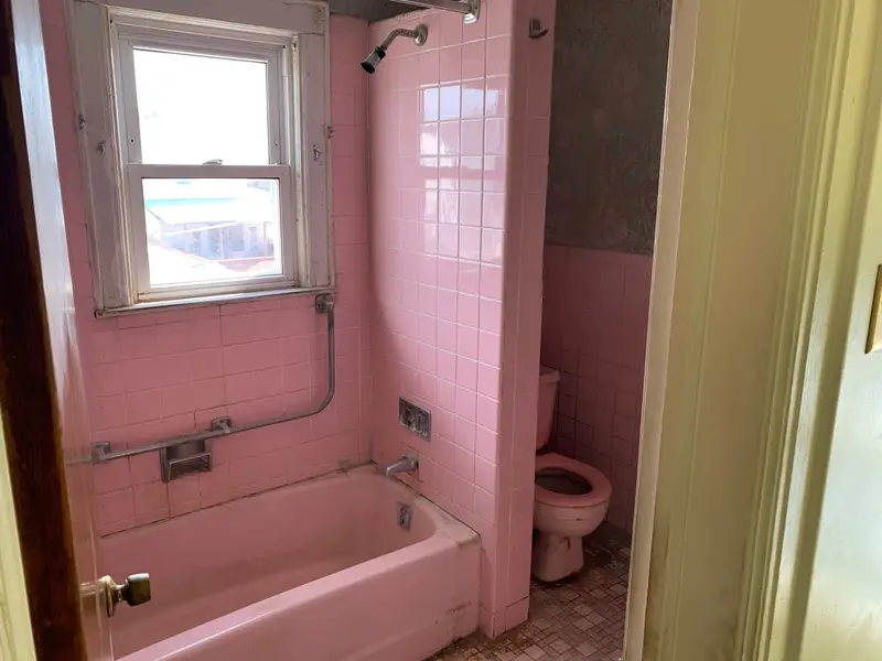 Pink-tiled bathroom with a matching tub, Valley Stream, NY